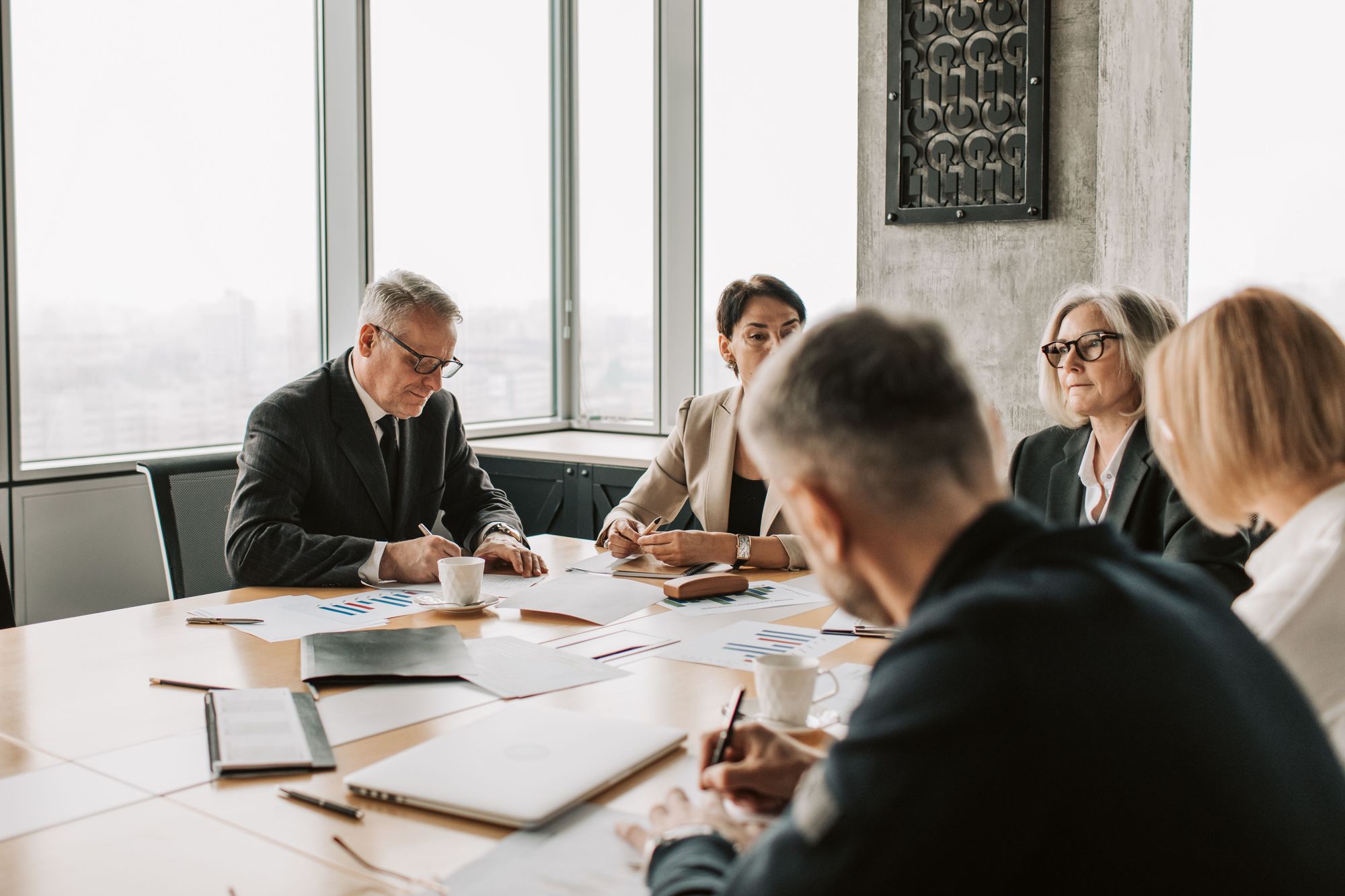 Senior advisors in discussion around a boardroom table